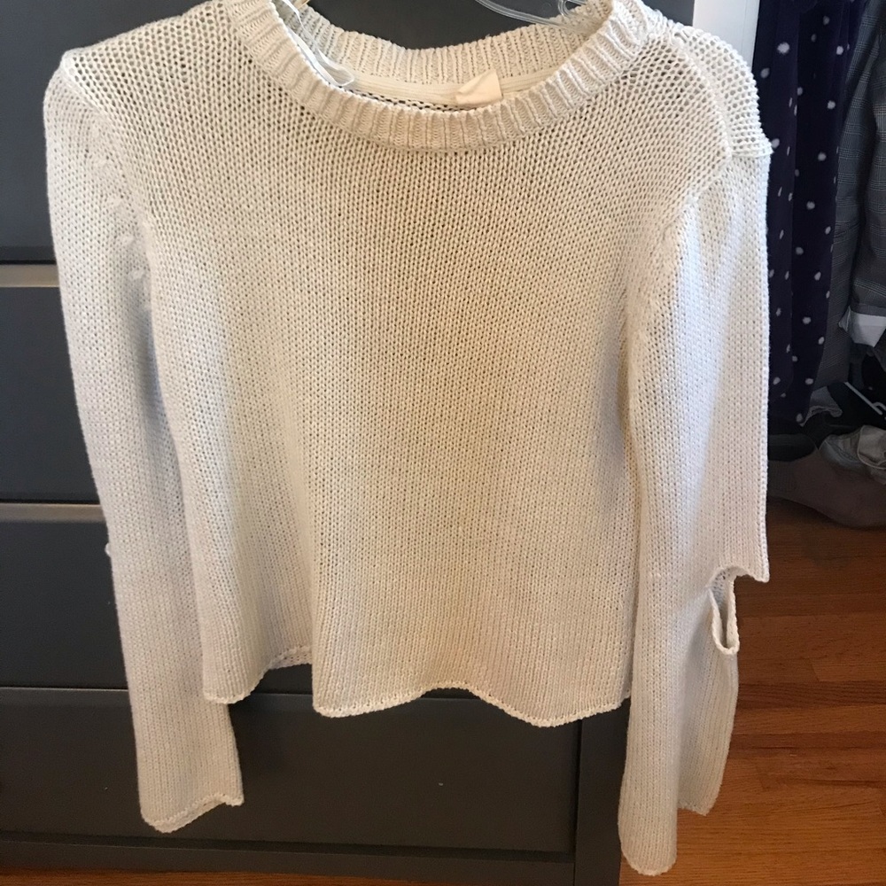 Cream sweater with elbow holes from “Cloth”